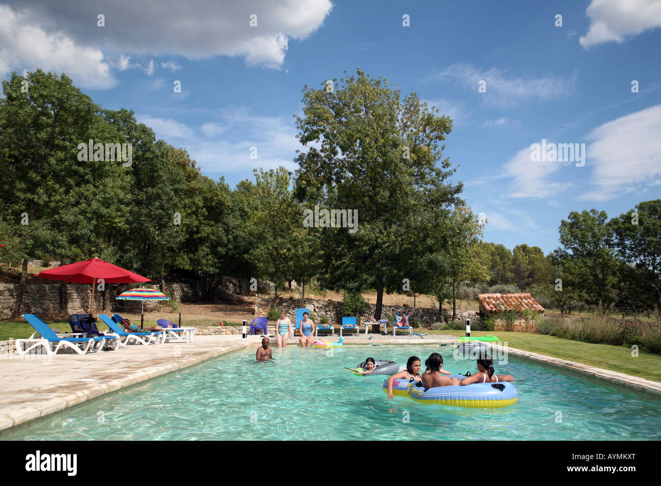 A Family Enjoys The Swimming Pool On A Hot Day In Provence France Stock Photo Alamy