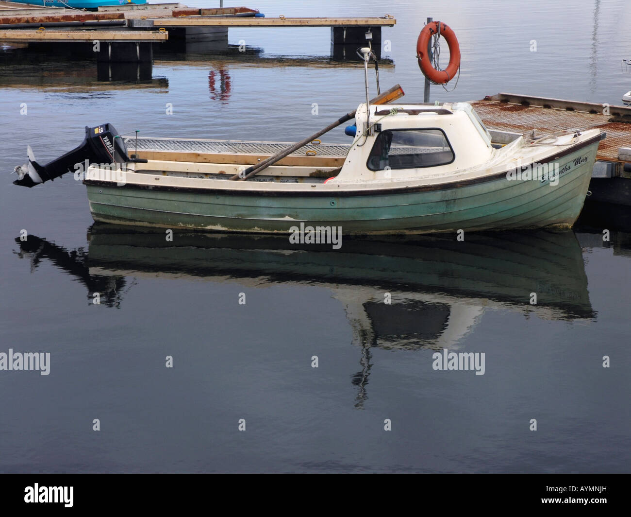 Fibre glass fishing boat with outboard motor in Cromarty Harbour, Black  Isle, Scotland Stock Photo - Alamy