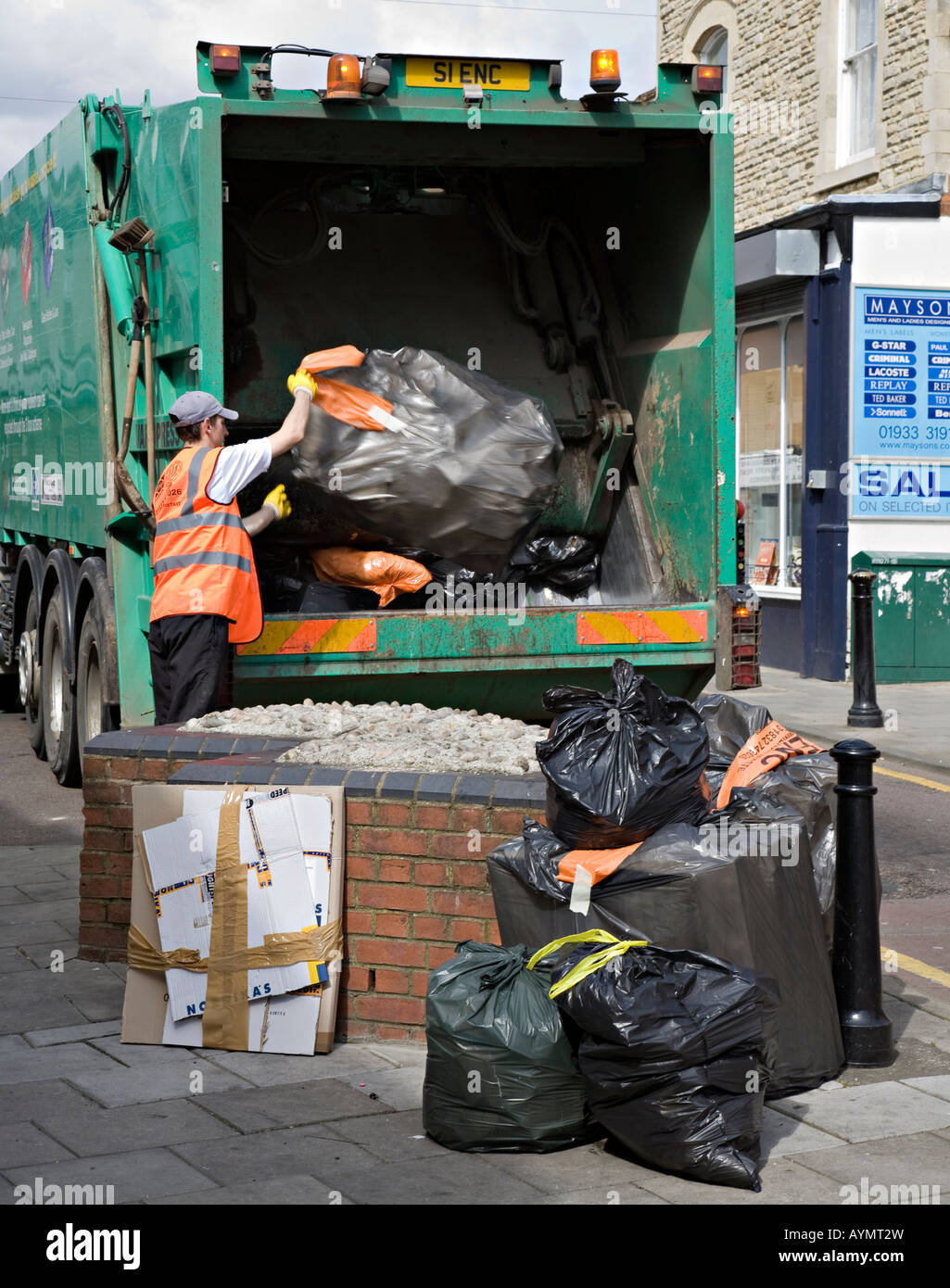 Rubbish in street being collected by council workman Rushden England UK
