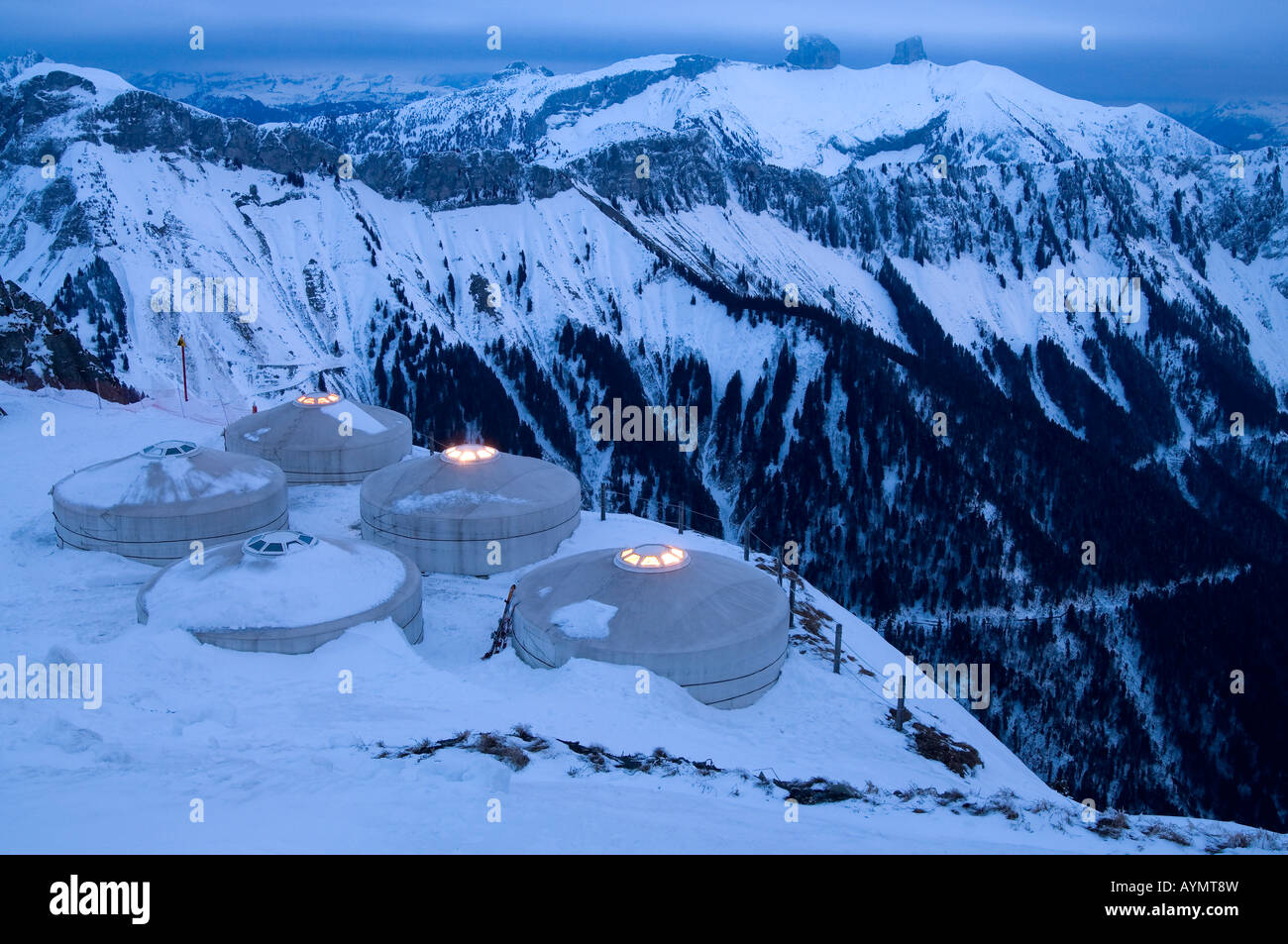 View of some tents in the peak of Rochers de Naye, in the Swiss Alps, central Europe,  with mountains in the background at dusk Stock Photo