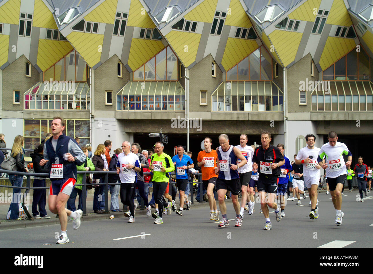 Group of runers at Rotterdam street City Marathon 13th April 2008, Netherlands, with Blaak street cubic houses architecture Stock Photo