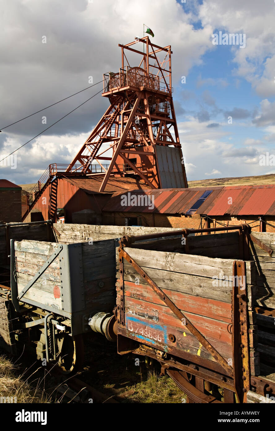 Pithead winding gear and railway trucks Big Pit mining museum Wales UK Stock Photo