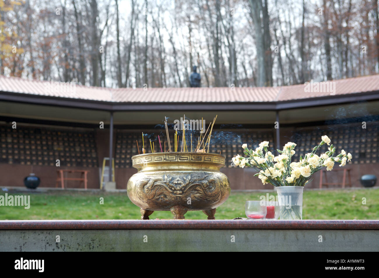 Praying bowl with Incense sticks at Buddhist monastery at burial place Stock Photo