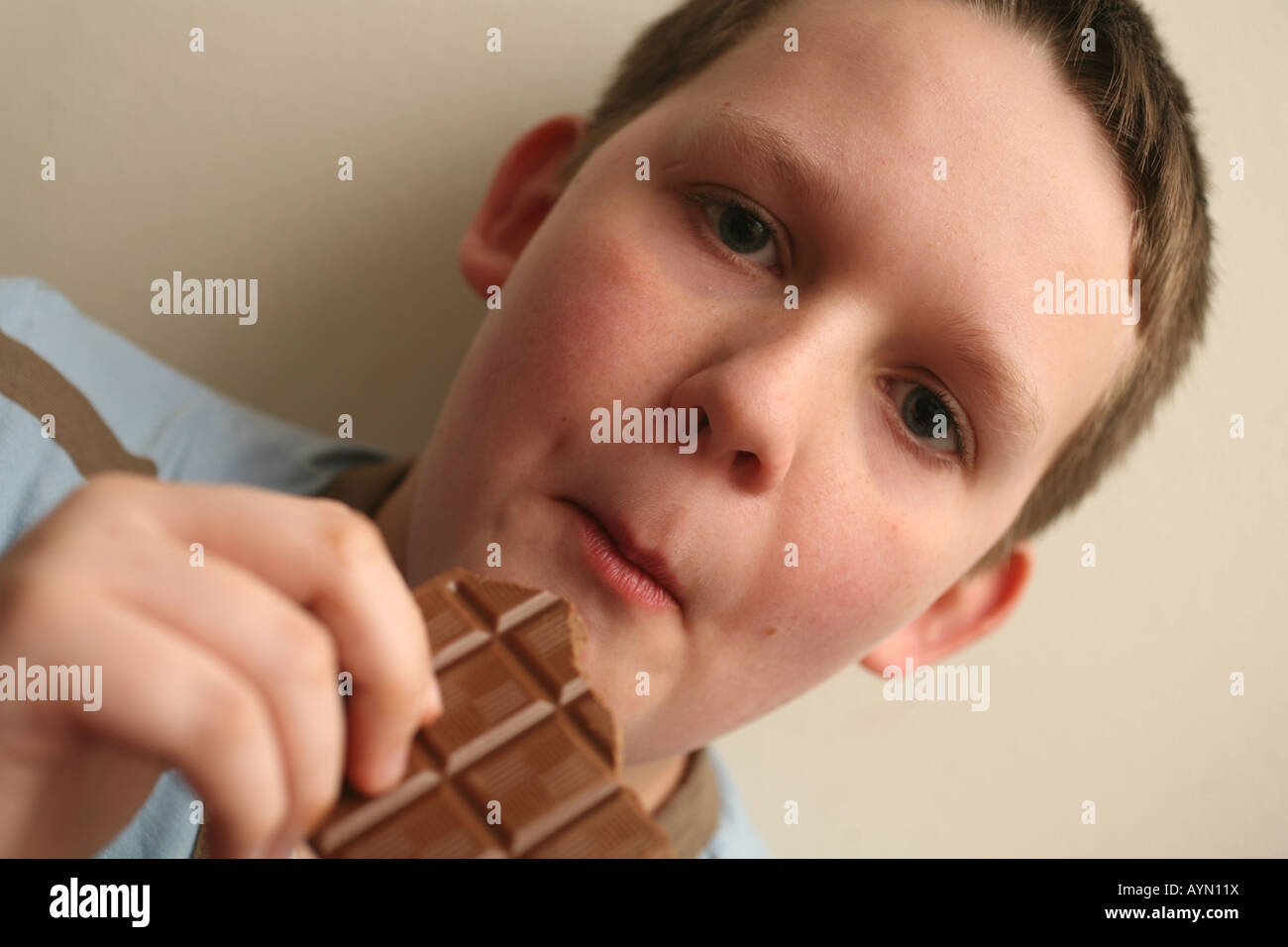 11 year old boy eating chocolate Stock Photo Alamy
