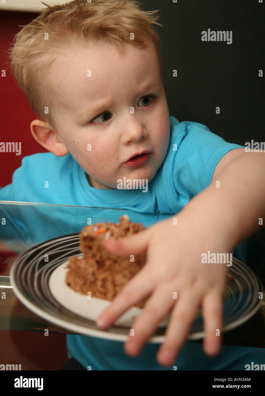 Toddler playing with food Stock Photo