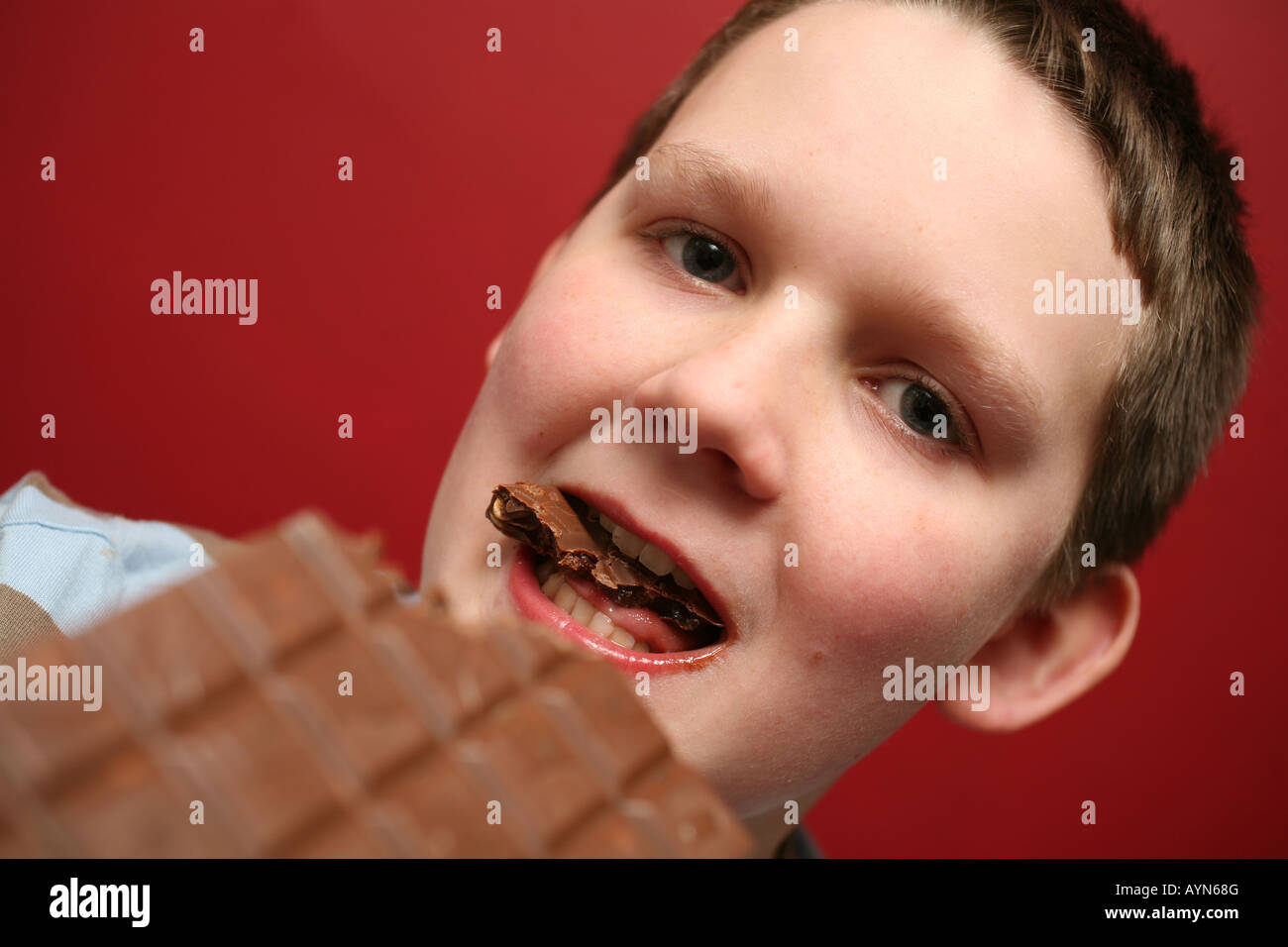 11 year old boy eating chocolate Stock Photo