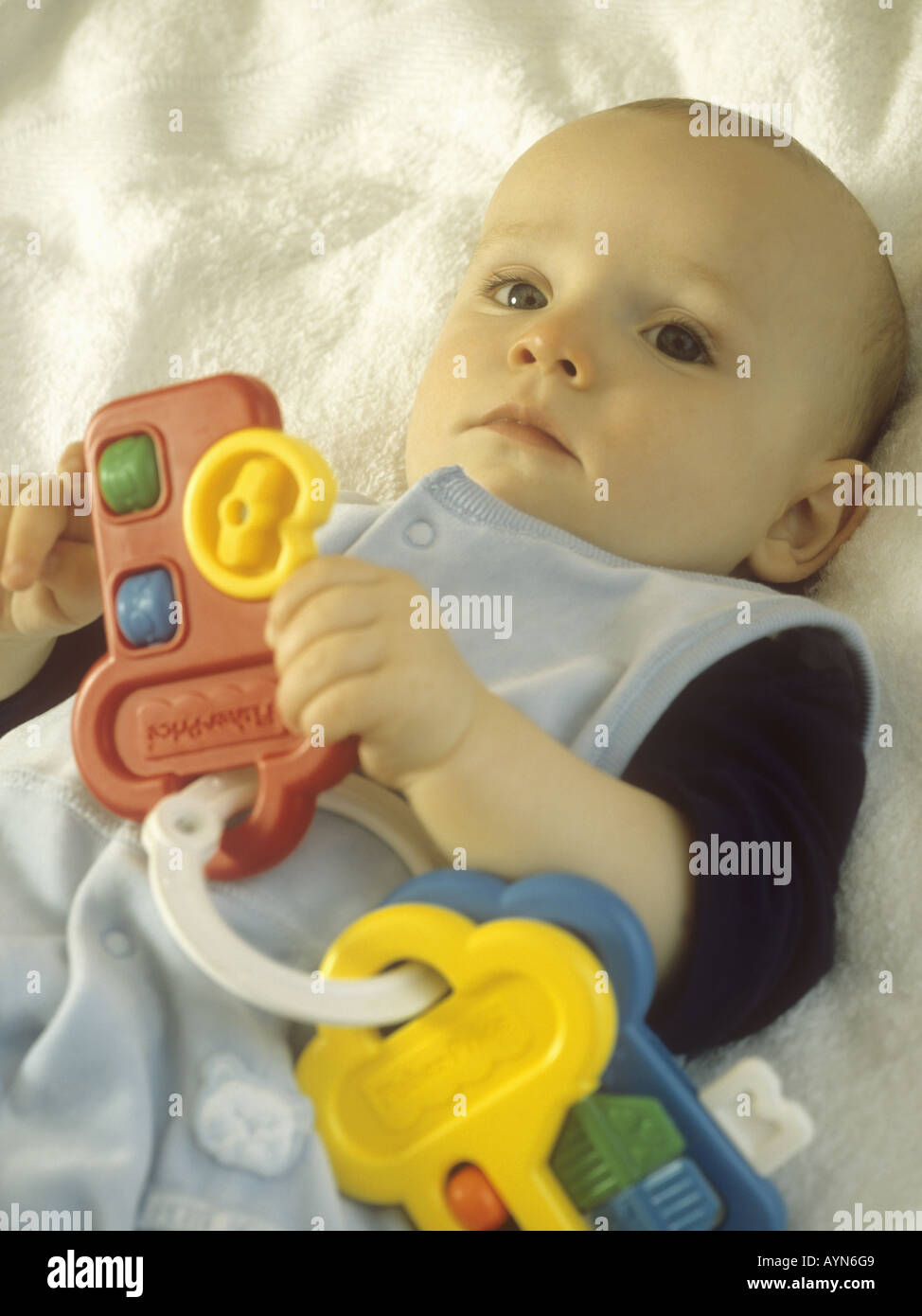 Baby boy playing with plastic toy keys Stock Photo Alamy