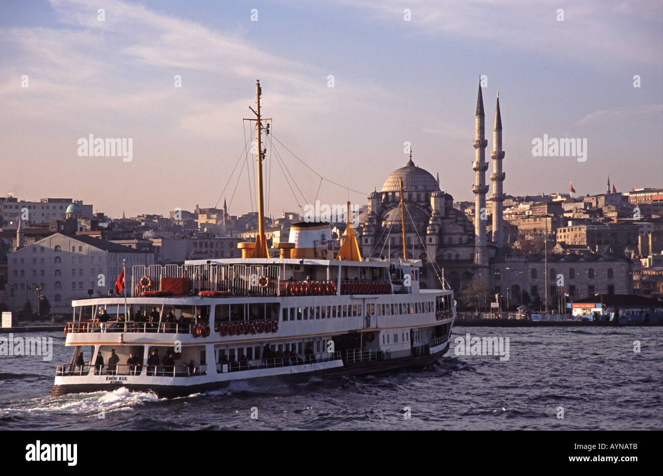 ISTANBUL, TURKEY. A Bosphorus ferry on the Golden Horn with the Yeni Camii behind. Stock Photo