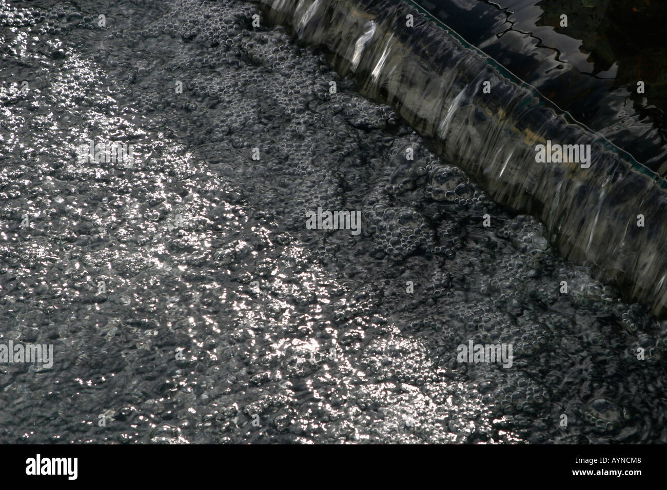 Close up of untreated water flowing into a water storage tank Stock
