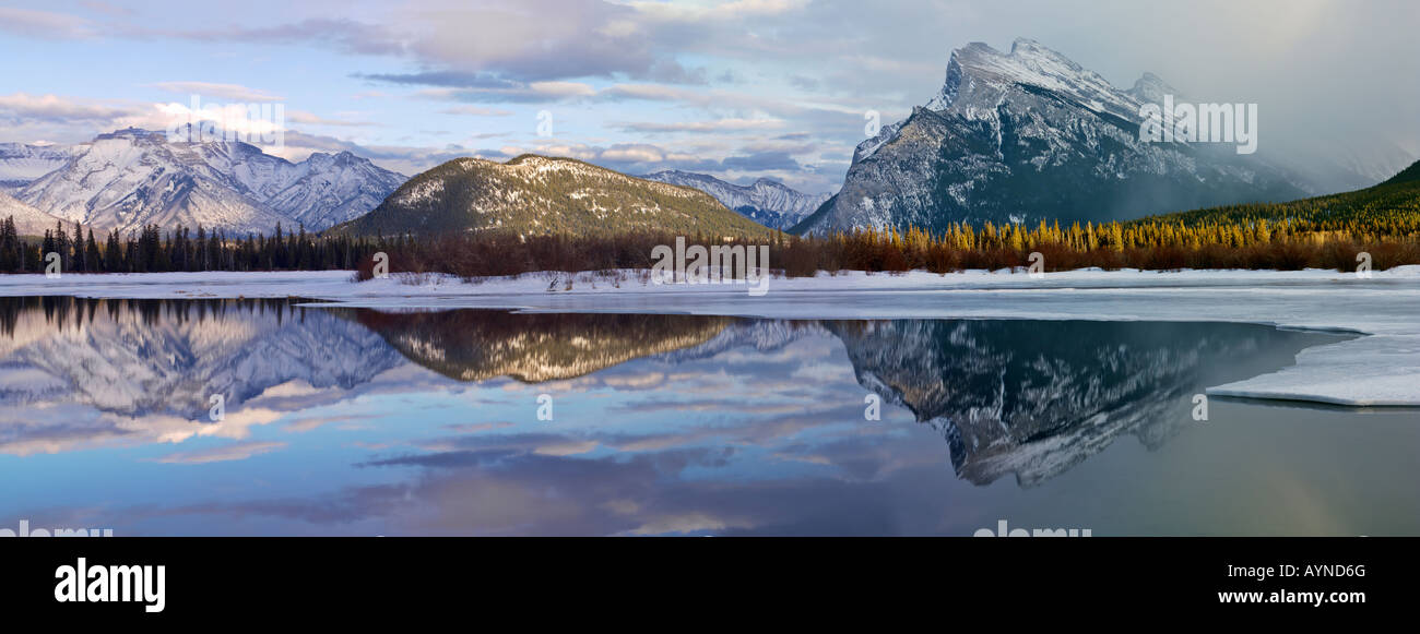 Canada, Alberta, Banff Banff National Park,Vermilion Lakes in winter with Fairholme Mountain Range and Mount Rundle reflecting in the lake. Stock Photo