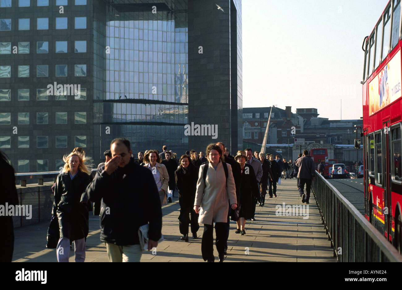 Commuters walking over London Bridge in the early morning rush hour