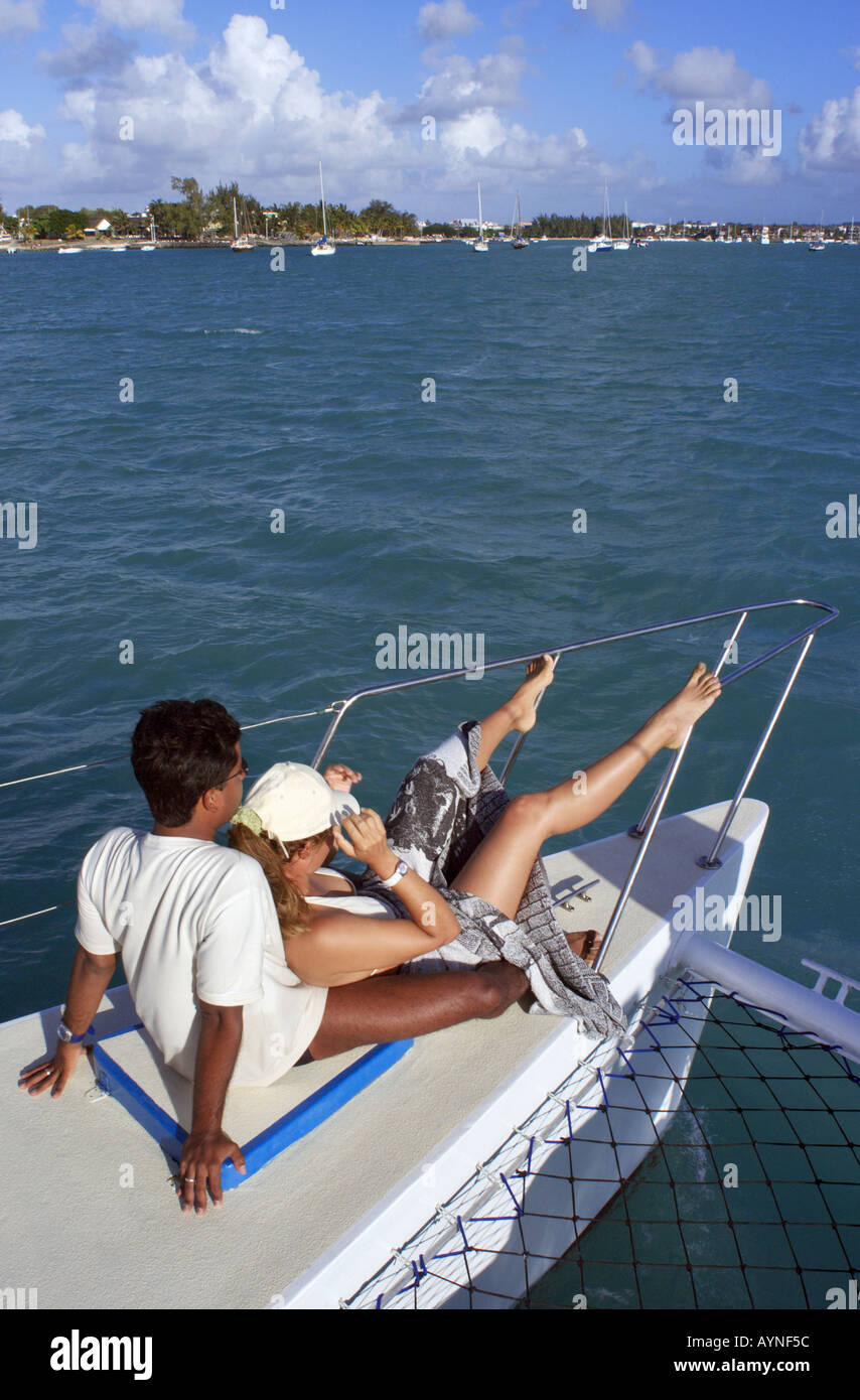 couple sitting on deck of a catamaran Stock Photo