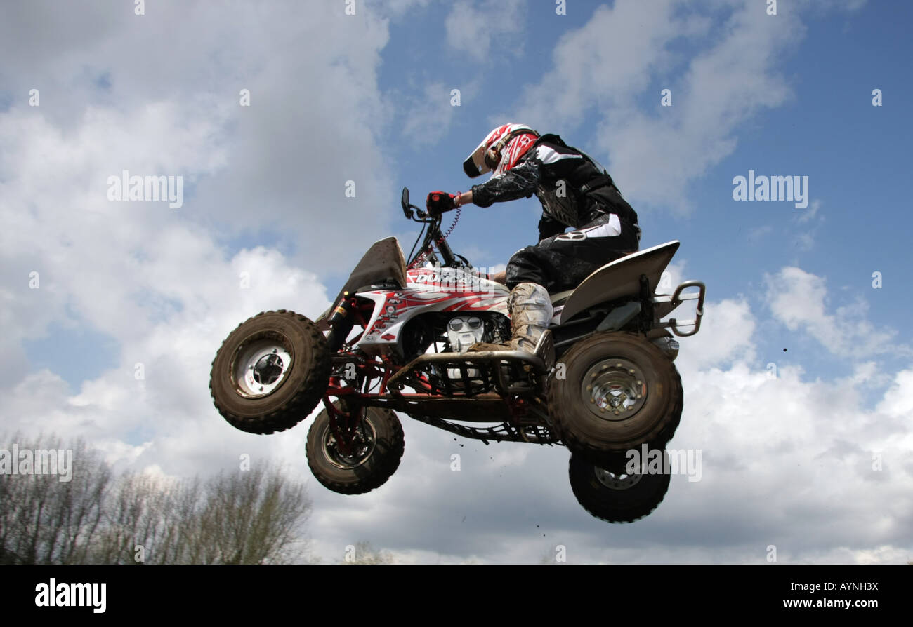 A quad racer clears a tabletop jump at Mildenhall Stock Photo Alamy