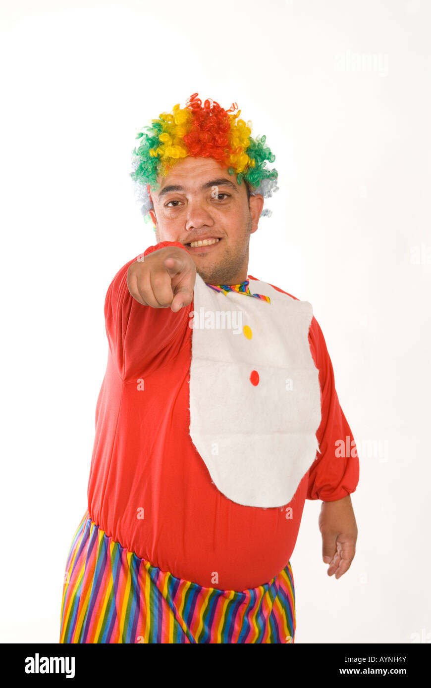 Half length portrait of a midget clown pointing at camera against a white background Stock Photo