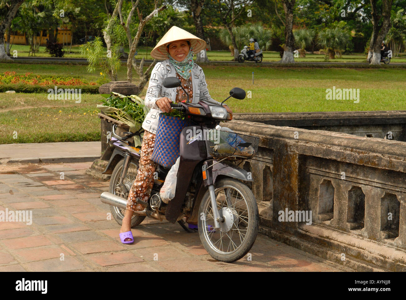 Woman on a motorbike city of Hué Vietnam Stock Photo
