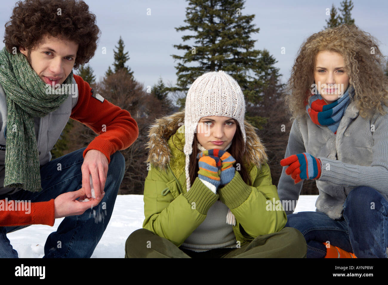 Two young women and a young man in winterly landscape Stock Photo - Alamy