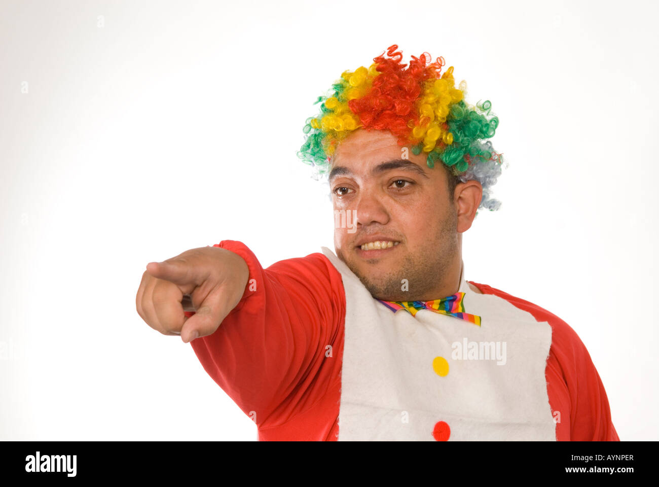 Head and shoulders portrait of a midget clown pointing finger against a white background Stock Photo
