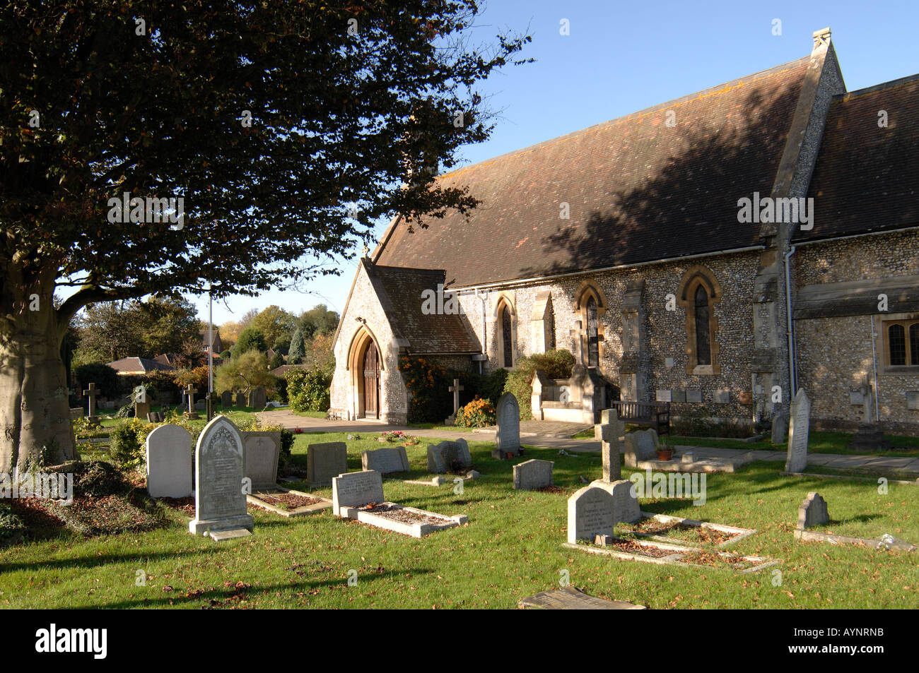 Sun shining on the church and graveyard of the Parish Church of St Margaret’s in Seer Green, Buckinghamshire. Stock Photo
