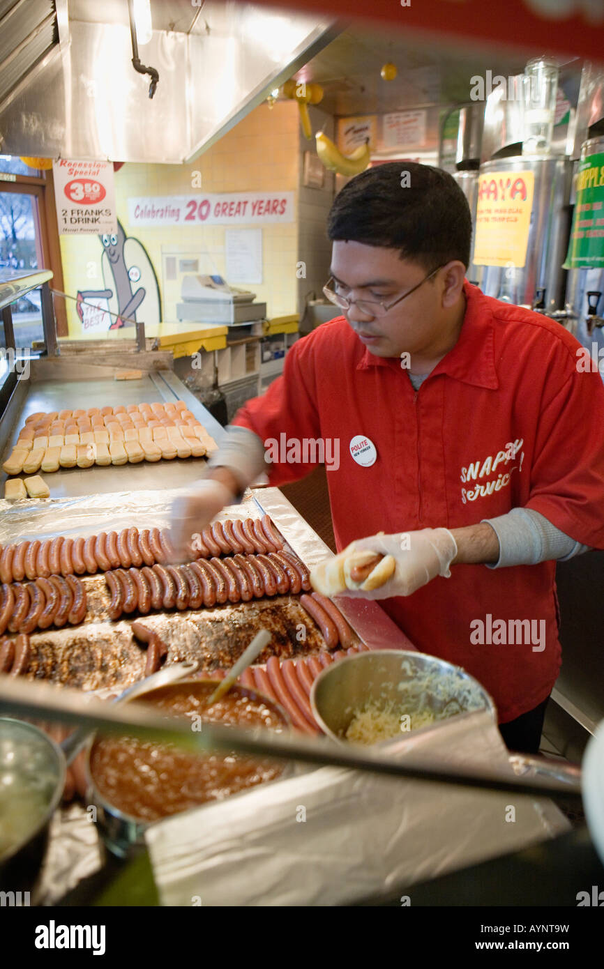 Making hot dogs at Grays Papaya West Village New York City Stock Photo