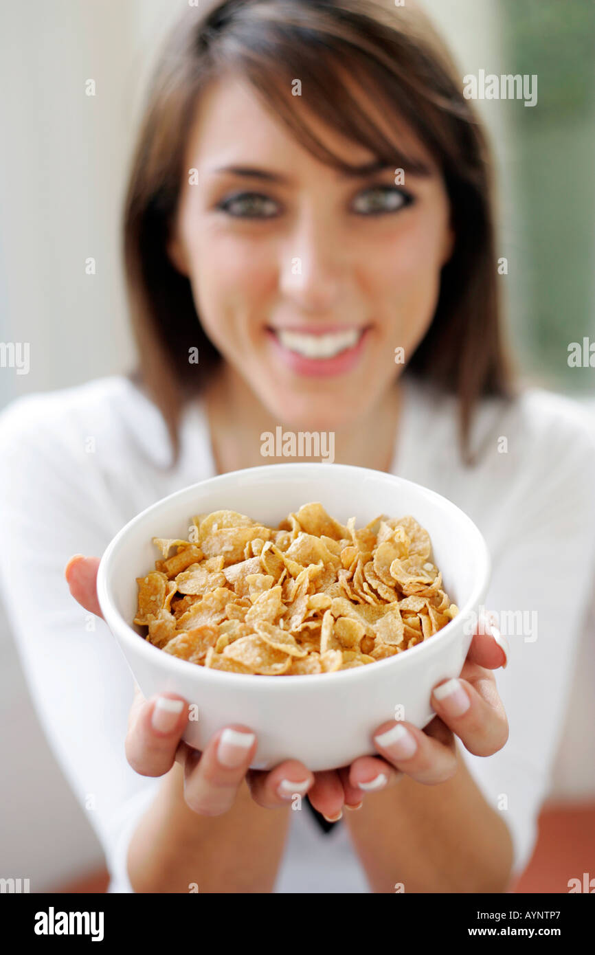 Brunette girl holding bowl of Cornflakes cereal Stock Photo
