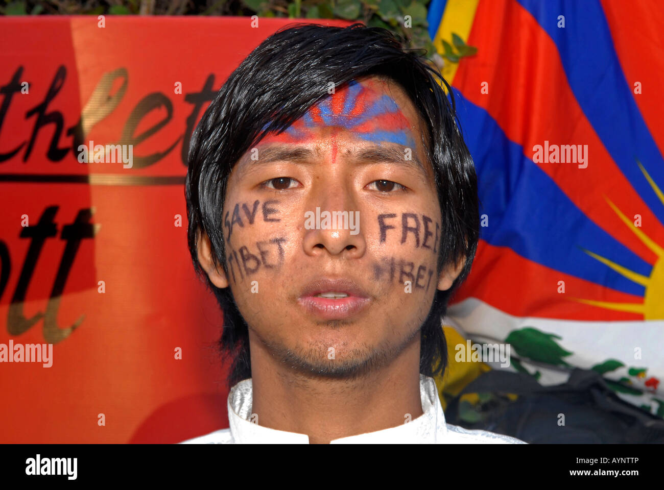 A man with Free Tibet and the Tibetan flag painted on his face taking part in a demonstration during Tibetan National Uprising Day in Tel Aviv Israel Stock Photo