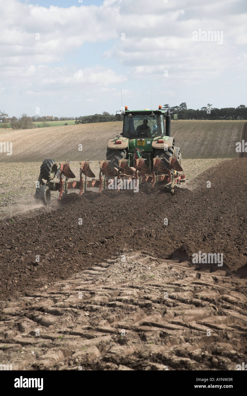 Tractor ploughing soil in preparation for potato crop, Butley, Suffolk