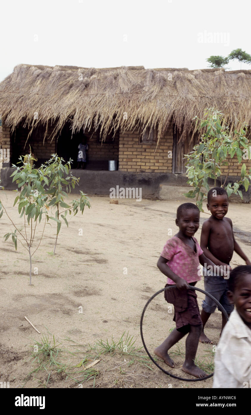 Happy children playing with a hula hoop - Nkhotakota, Lake Malawi, Malawi Stock Photo