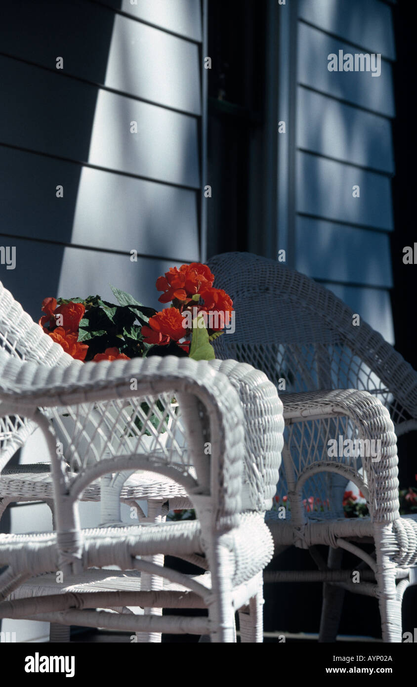 Wicker chairs on sunny home porch Stock Photo