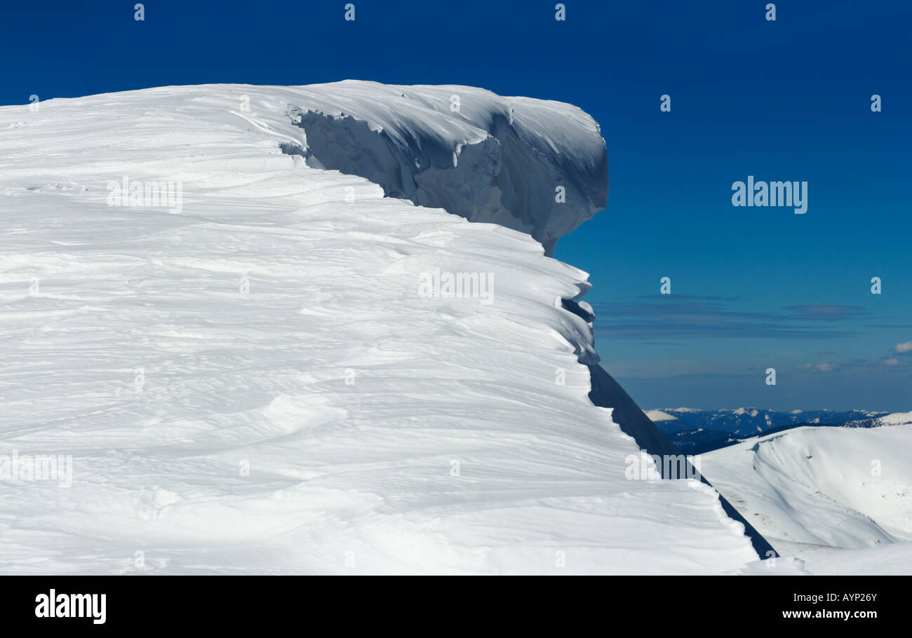 Winter mountain top with fairy overhang snow cap. Three shots stitch image Stock Photo