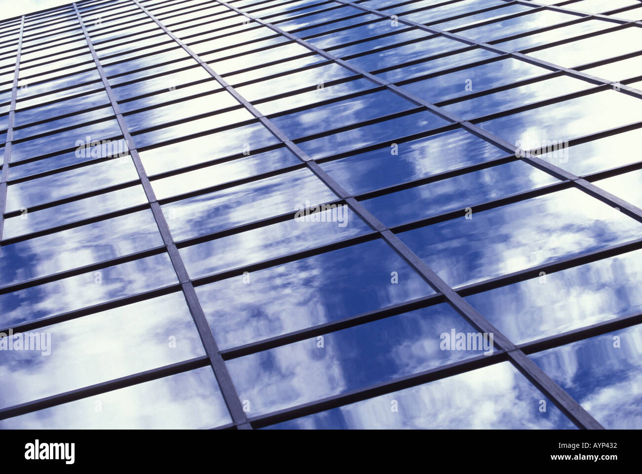 Glass and steel office building reflecting blue sky and clouds Stock ...