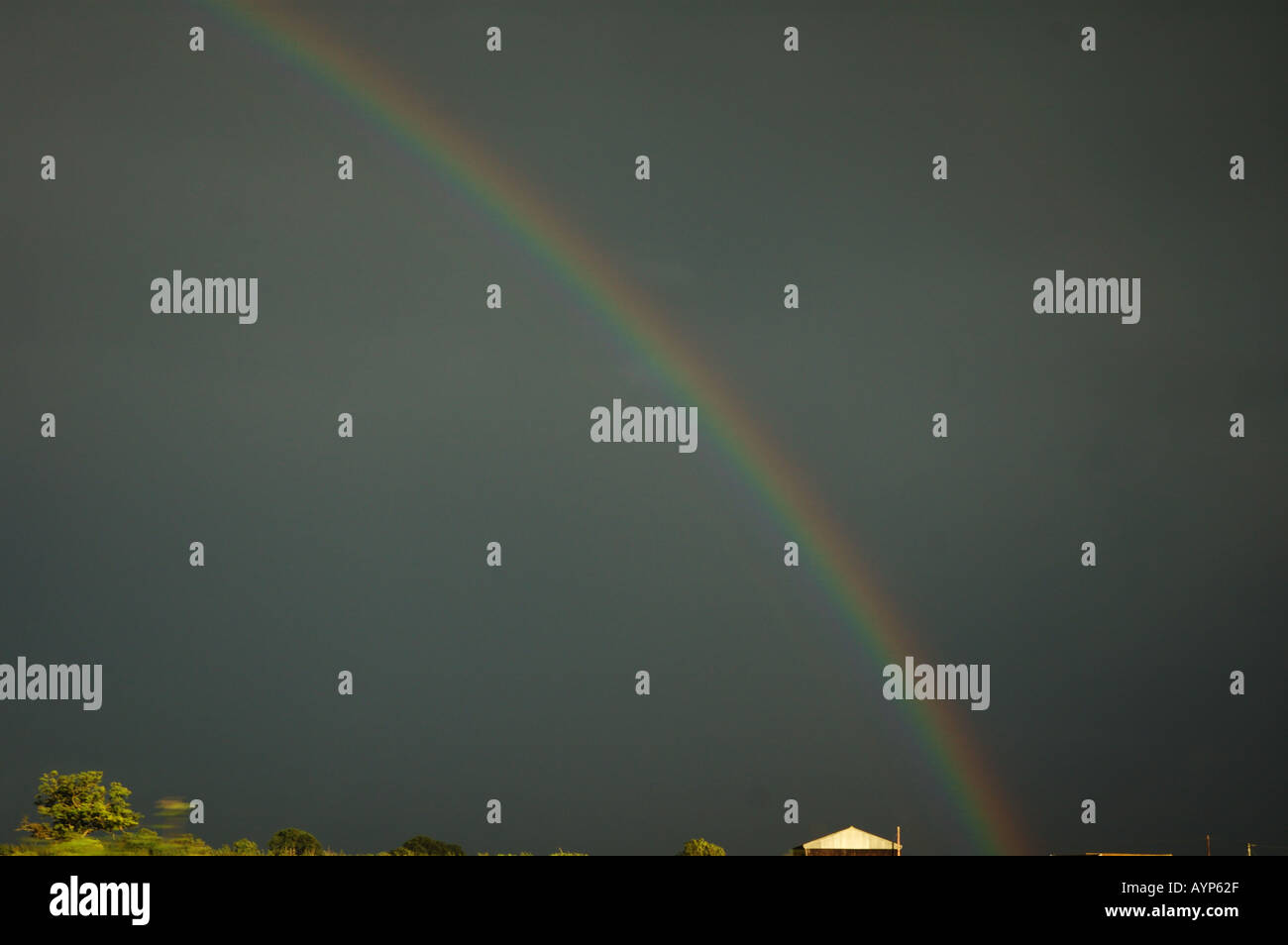 Dark sky and rainbow taken from moving vehicle Stock Photo - Alamy