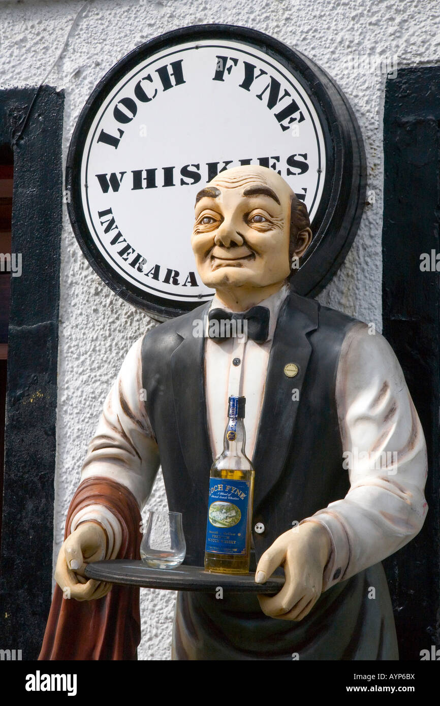 Butler statue with serving tray outside Loch Fyne Whiskies for sale sign; Scotland Whisky Shop, Inverary, UK Stock Photo