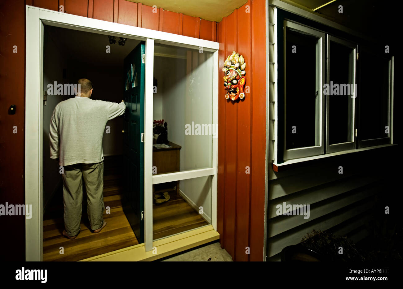Man Enters House Front Door Watched Over By Hindu God Mask