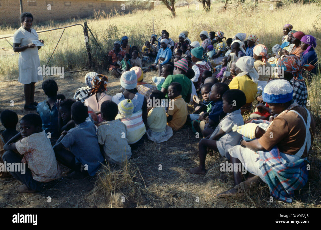 ZIMBABWE People Health Family Planning Association education officer and distributor talking to women on farming compound Stock Photo