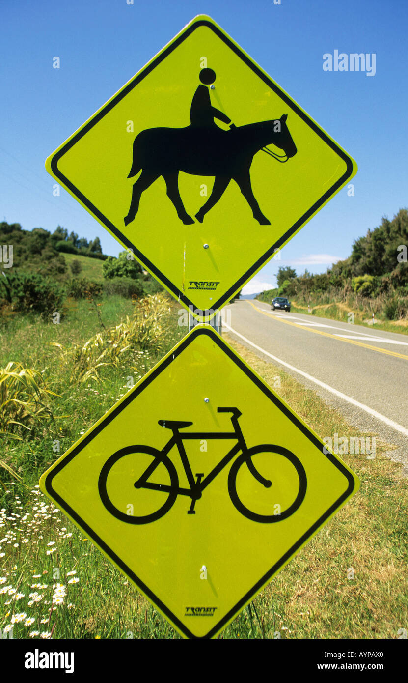 two-yellow-diamond-shaped-road-signs-the-top-one-with-a-horse-and-rider