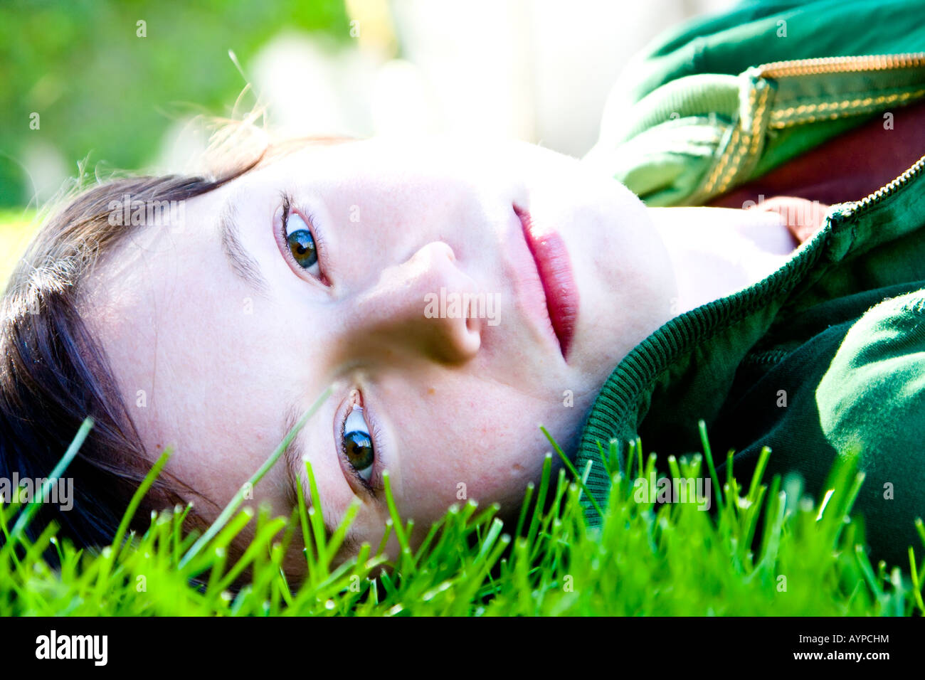 Young woman staring at camera in the grass Stock Photo