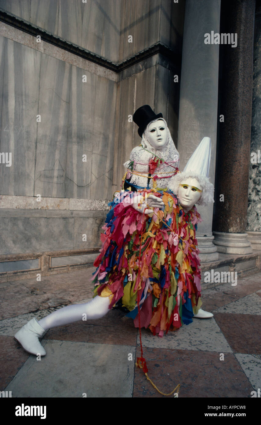 ITALY Veneto Venice Two Carnival masqueraders in costume in the street. Stock Photo