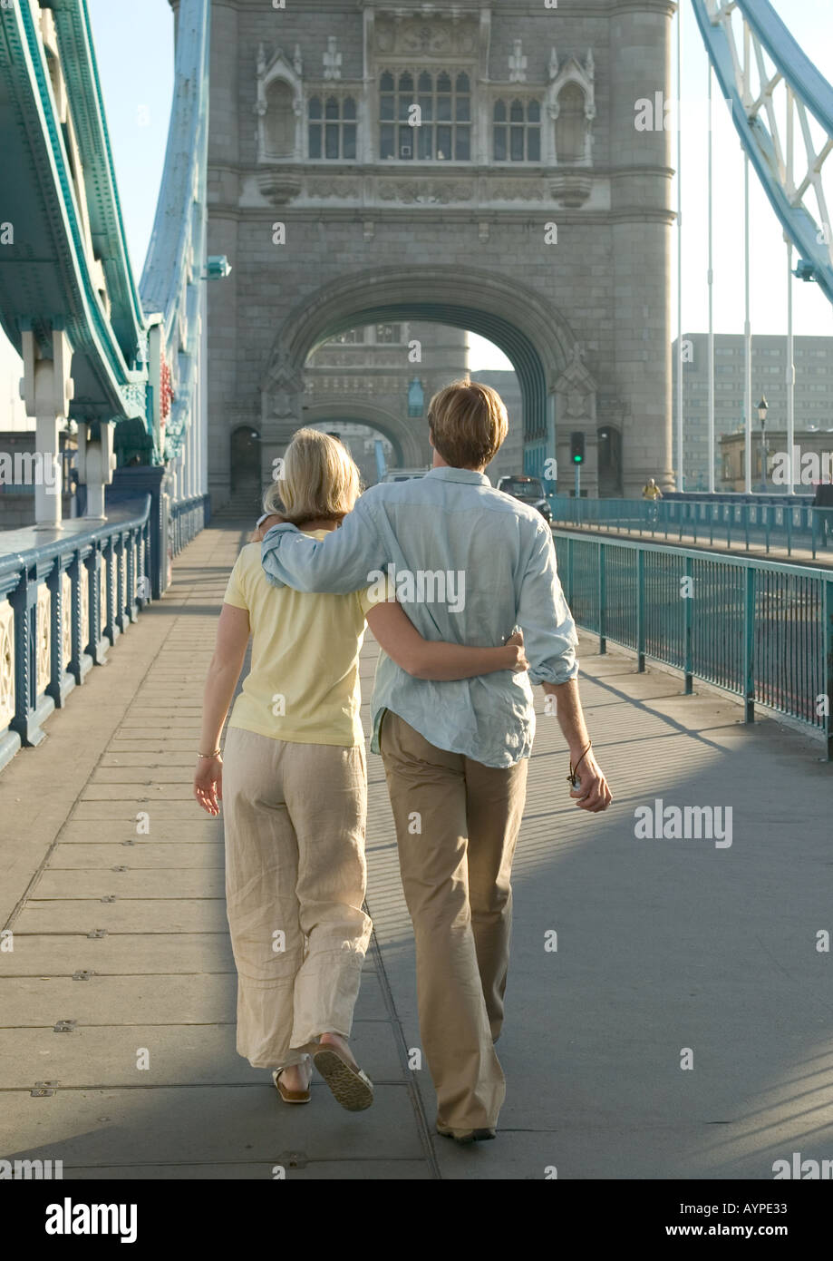 couple strolling arm in arm over tower bridge Stock Photo