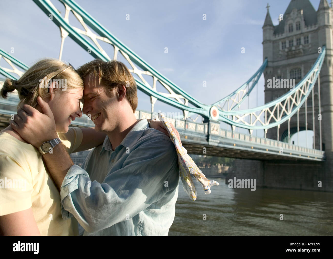 couple standing near tower bridge kissing in london Stock Photo