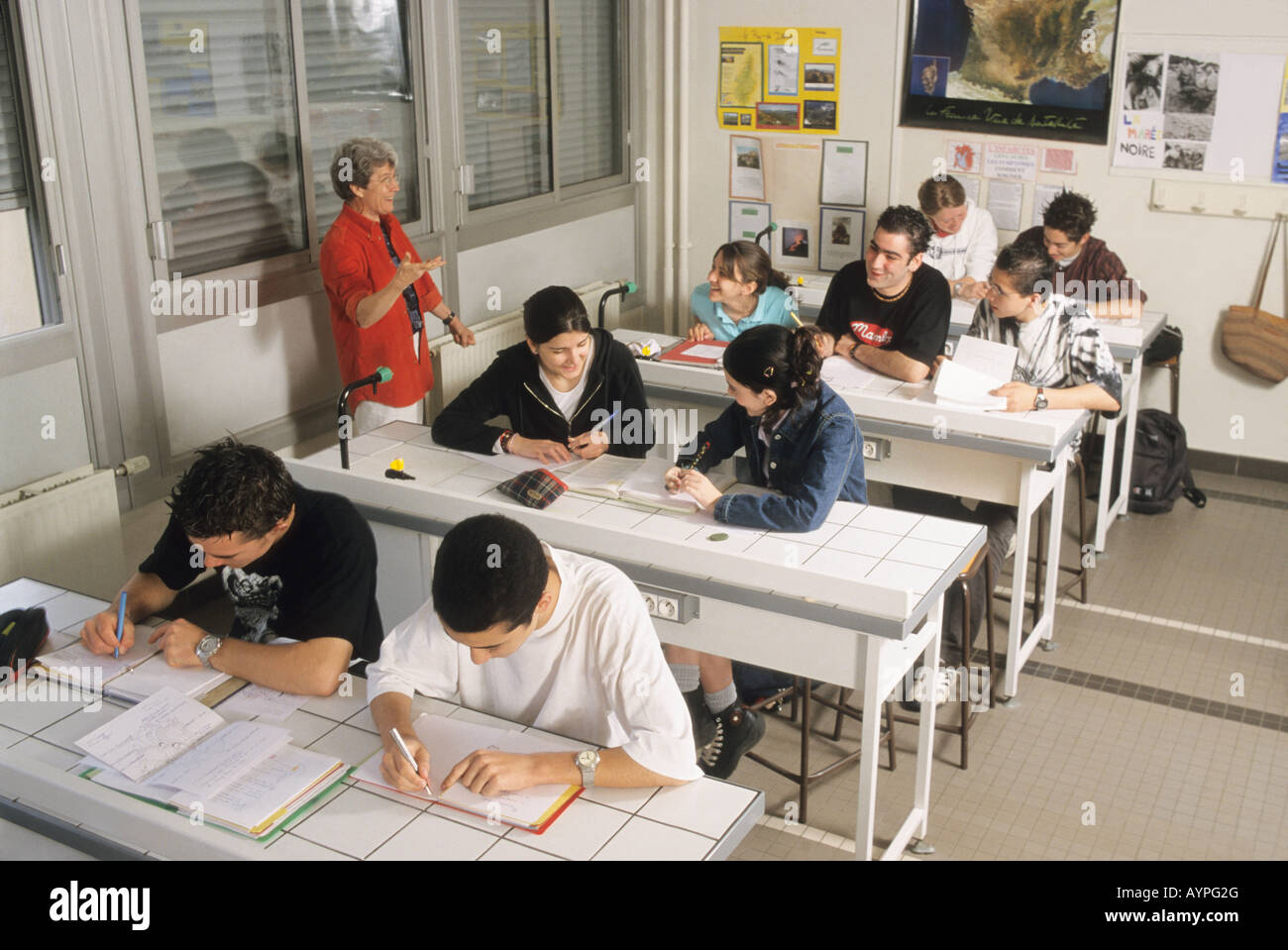 Teacher talks to high school students in classroom, Paris France Stock Photo