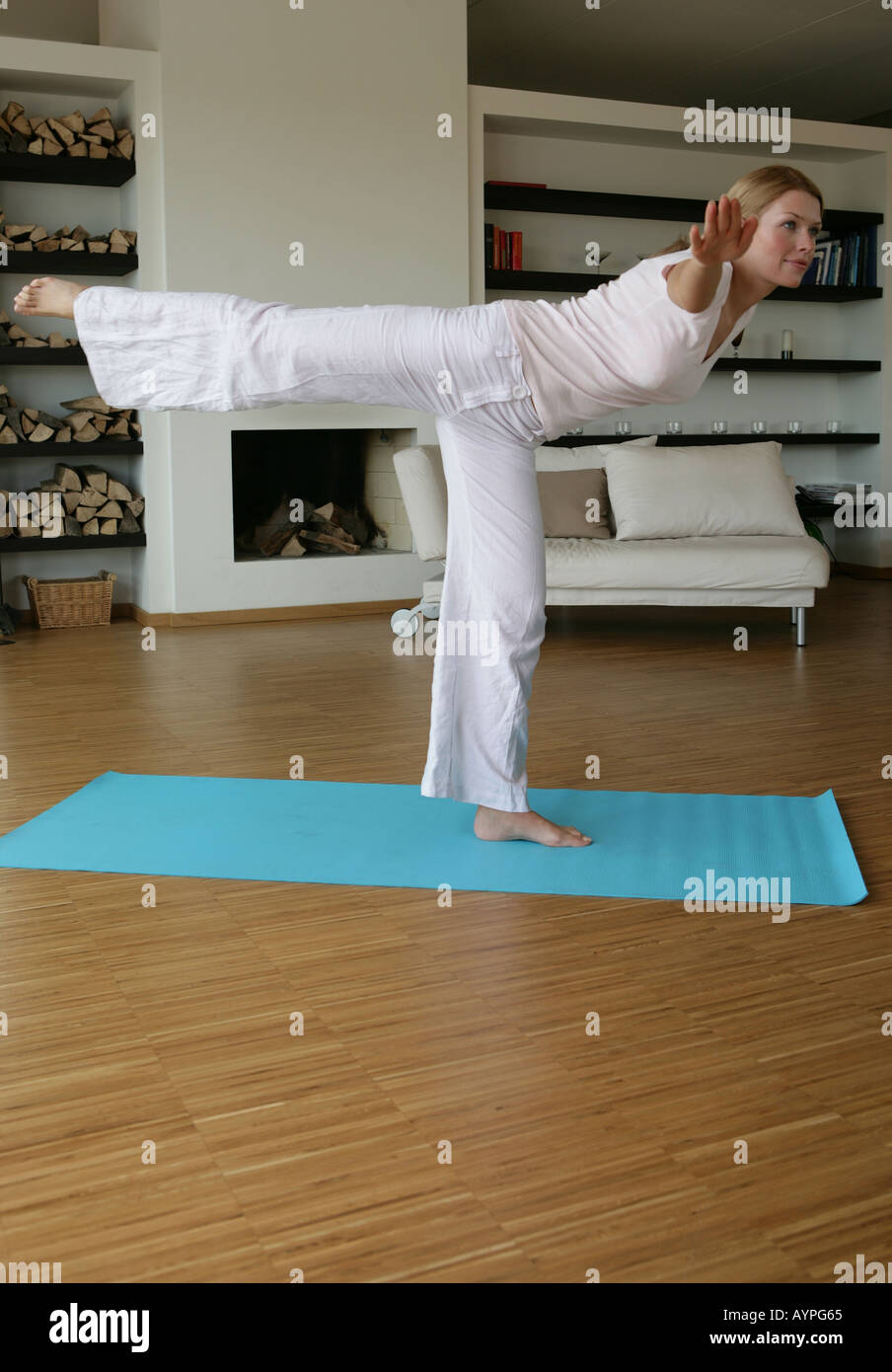 A blonde woman exercising in her hall Stock Photo - Alamy