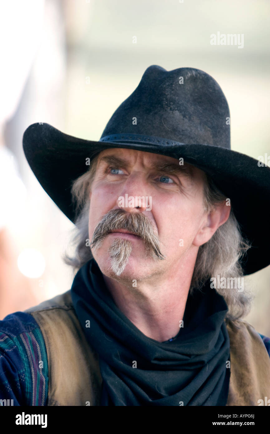 A working cowboy on a ranch in colorado in a hat and bandanna Stock Photo
