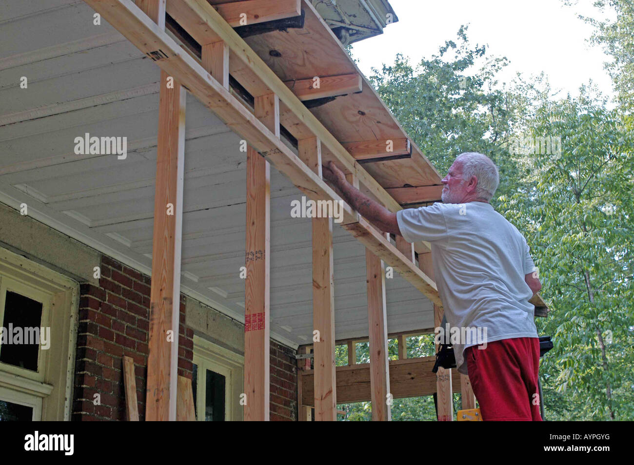 Carpenter builds porch on Victorian home, historic preservation, careers Galena Ohio USA midwest Stock Photo