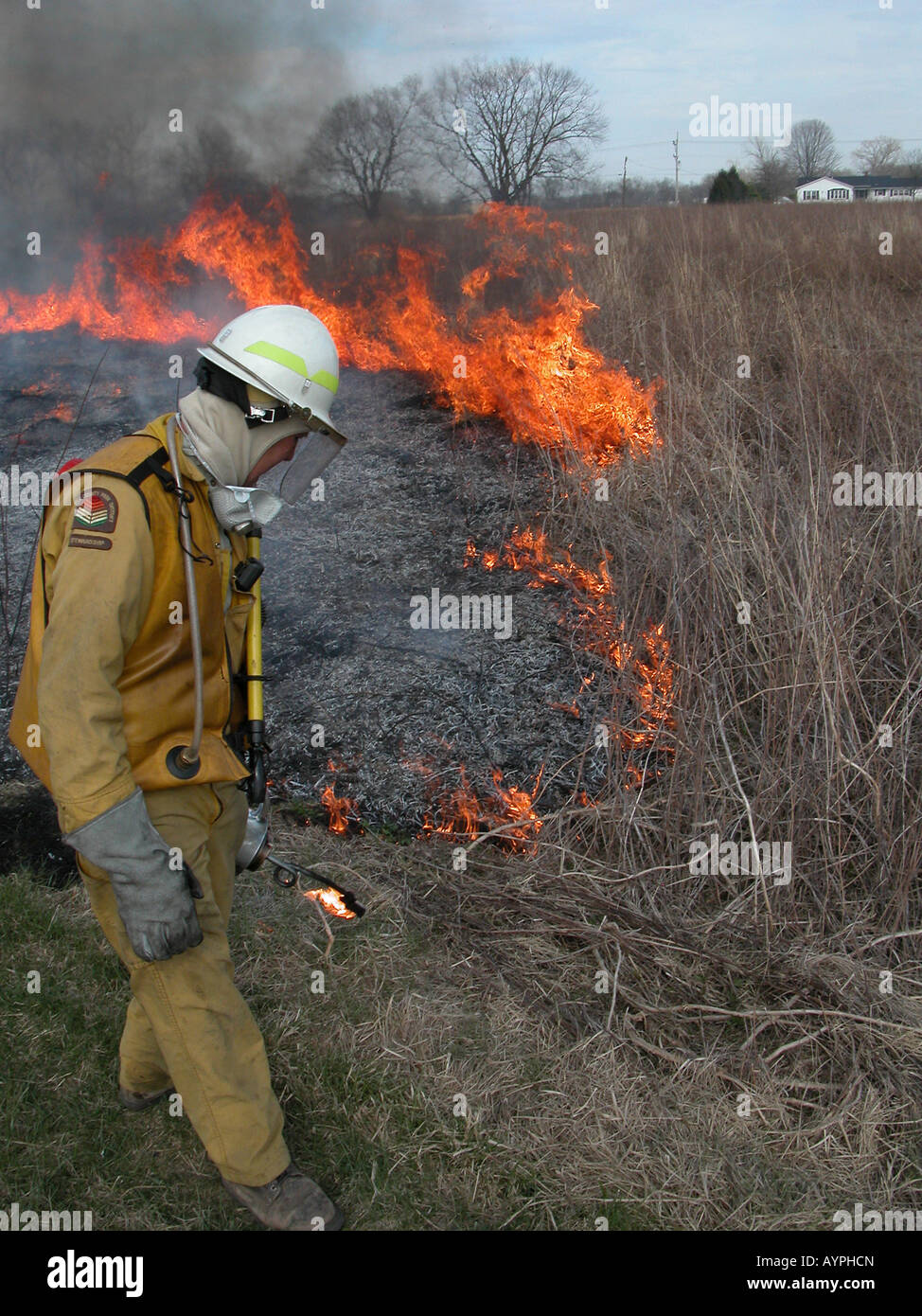 firefighter controlled prairie burn prescribed maintenance restoration flames fire restoration grass land fireman Stock Photo