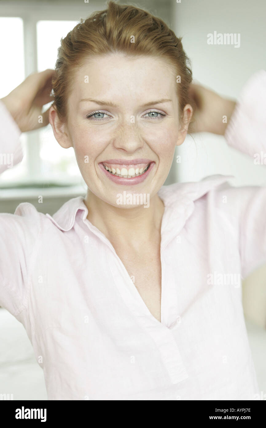 A blonde woman smiles as she looks at the camera Stock Photo - Alamy