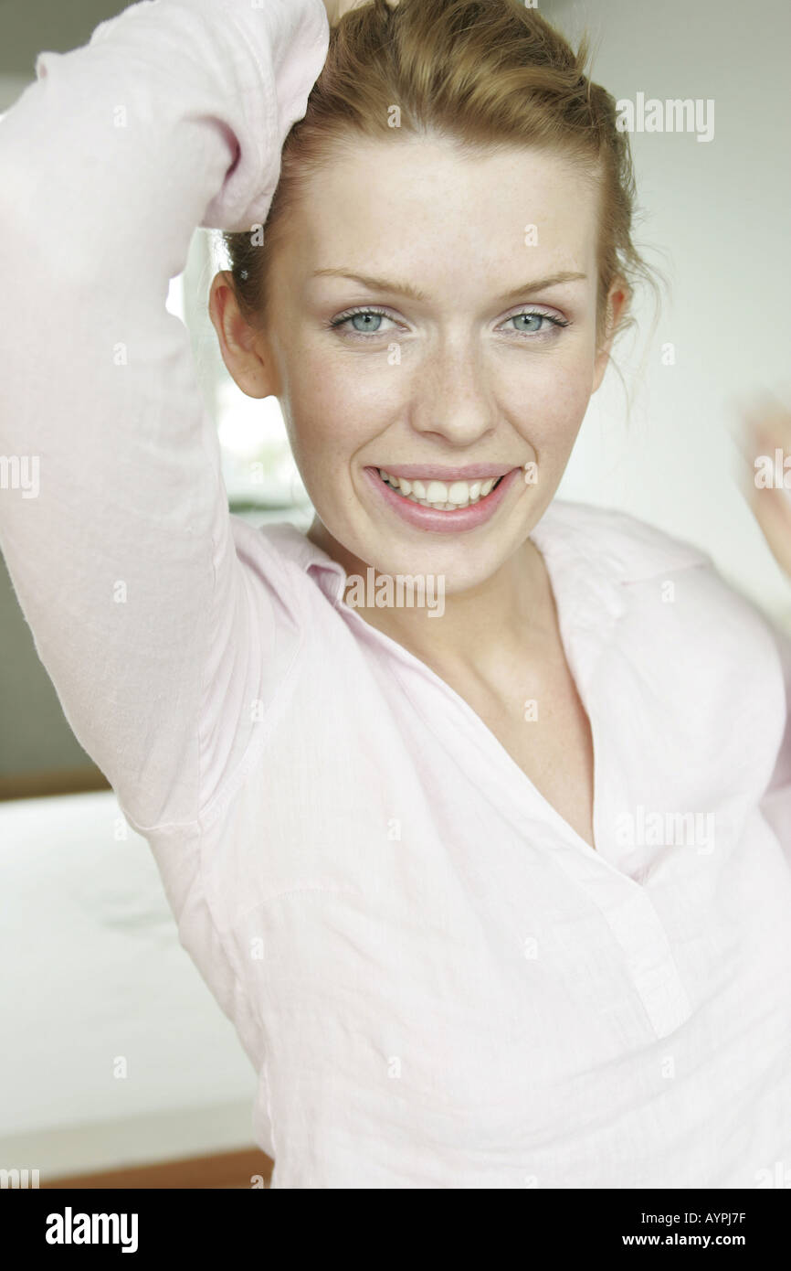A blonde woman smiles as she looks at the camera Stock Photo - Alamy