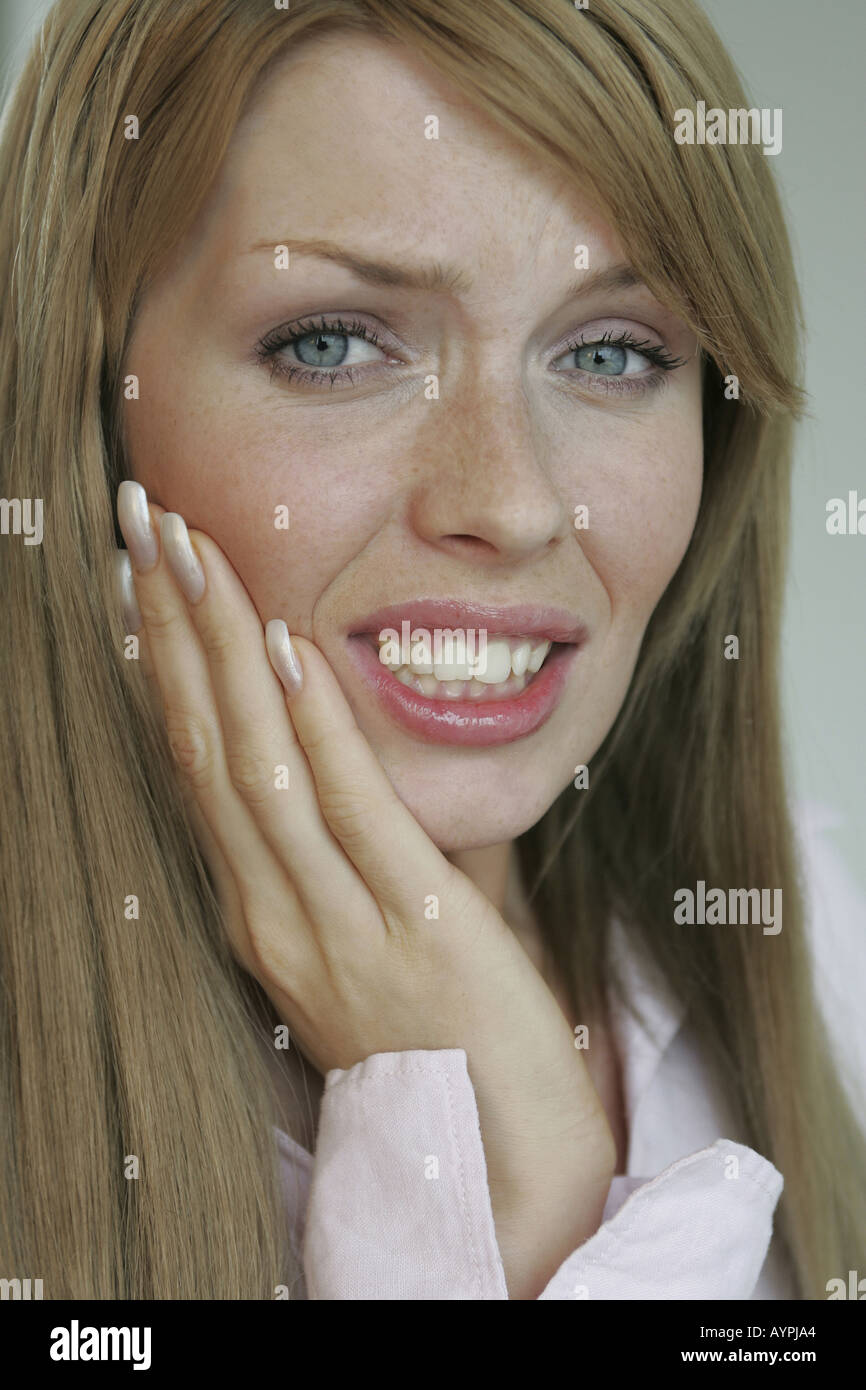A blonde woman suffering from a toothache Stock Photo