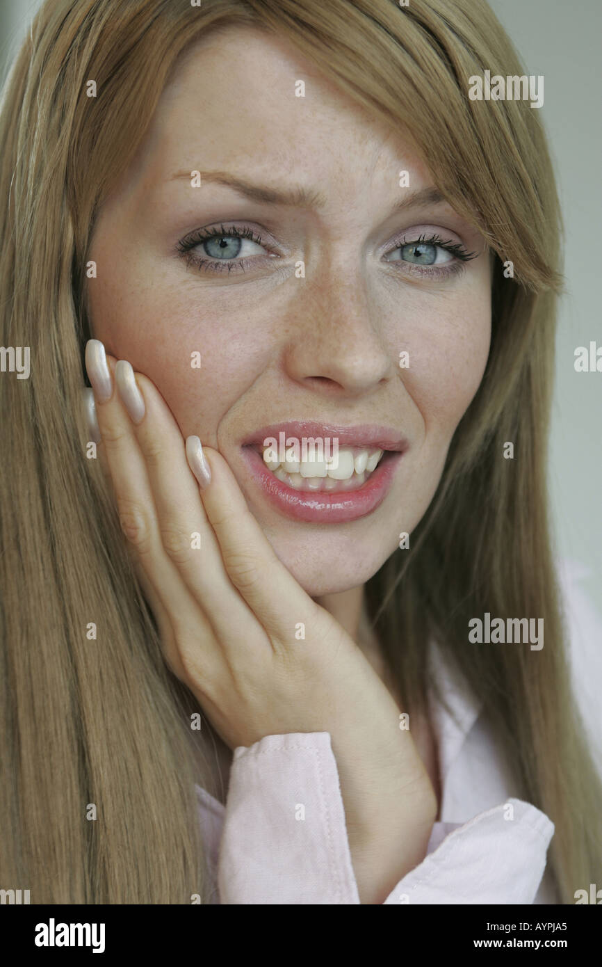 A blonde woman suffering from a toothache Stock Photo