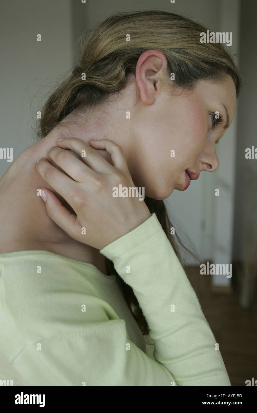 Sting in the neck of a blonde woman Stock Photo