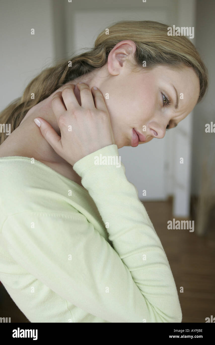 Sting in the neck of a blonde woman Stock Photo